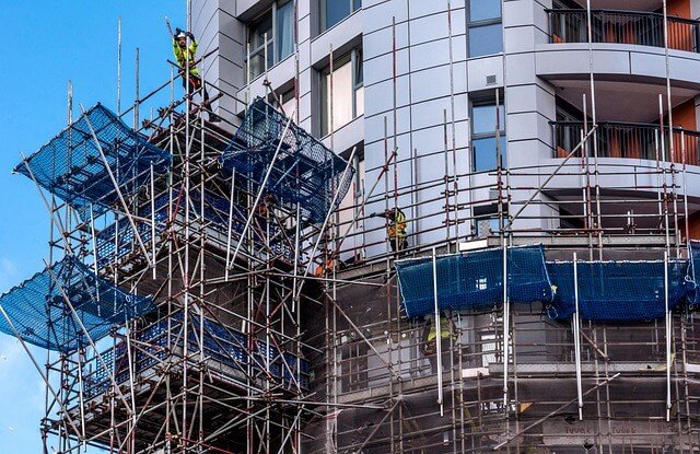 Custom multi-angled ringlock modular scaffold setup wrapping around complex exterior building architecture parameters